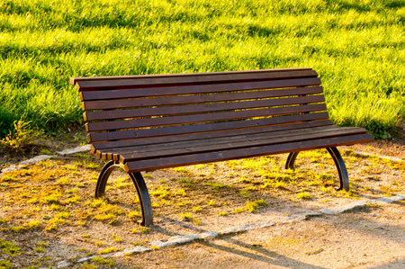 Wooden bench in a park at sunset