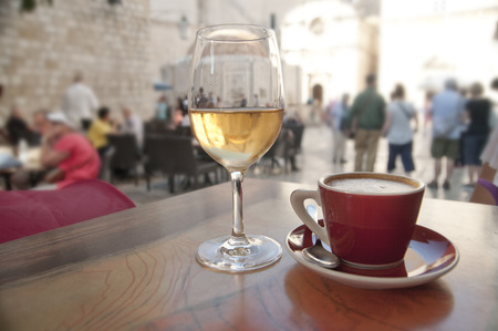 Wine and coffee at a cafe by a crowded street. Sightseeing concept.の写真素材