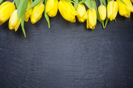 Happy Mother's Day! yellow tulips on black background, greeting cardの写真素材