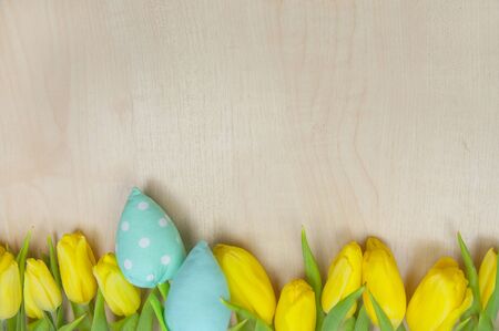 Spring background, yellow tulips on wood with copy space, flat layの写真素材