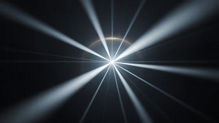 This image showcases an abstract light burst emanating from a central point against a dark background The light rays are sharply defined and radiate outwards creating a sense of energy and focus The contrast between the bright light and the dark background is striking emphasizing the radiant power of the central light source The composition is minimalistic and highlights the interplay of light and shadow in an intriguing way The image may evoke concepts such as enlightenment breakthrough or technological advancementの素材