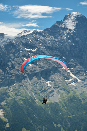 Paraglider under the Eiger summit in Bernese Alps, Switzerlandの写真素材