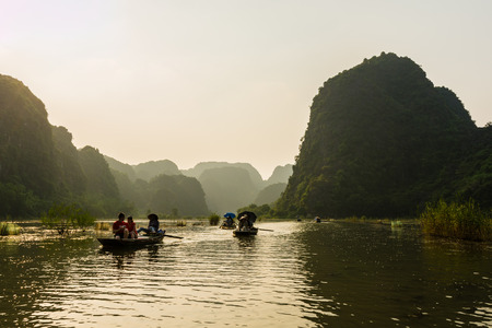 NINH BINH, VIETNAM - OCTOBER 2014 - Sightseeing cruise on small river surrounded by mountains near Ninh Binh in Vietnamのeditorial素材