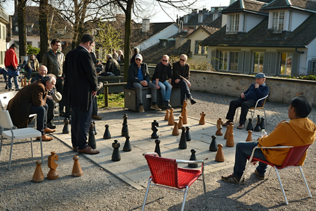 ZURICH, SWITZERLAND - MARCH 2017 - People enjoying exciting chess battle in Lindenhof park in Zurichのeditorial素材