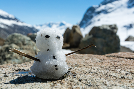 Small snowman on rockの写真素材