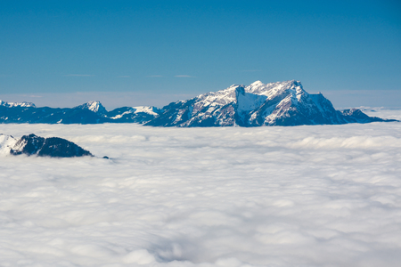 Mount Pilatus rising above the dense clouds in Swiss Alpsの写真素材
