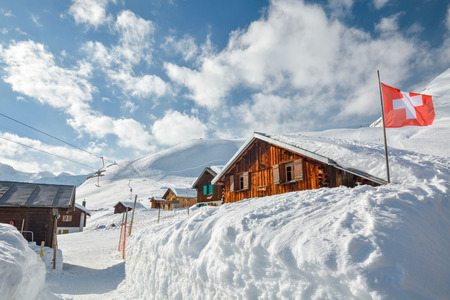Wooden huts covered by snow in Sedrun ski resort in Switzerlandのeditorial素材