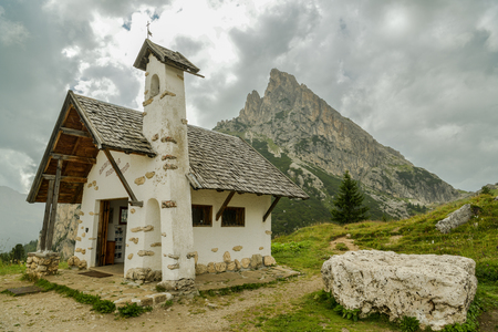 Small chapel in Falzarego pass in Dolomites mountains in Italyの写真素材
