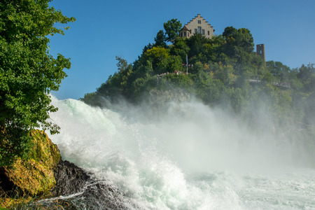 Schaffhausen, Switzerland - July 18, 2015: People on observation platform near castle Laufen in Schaffhausen, Switzerland watching Rheinfall, the largest waterfall in Europe during summer 2015のeditorial素材