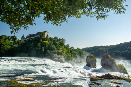 Schaffhausen, Switzerland - July 18, 2015: People on observation platform on tall rock in the middle of Rhein river looking at Rheinfall, the largest waterfall in Europe near city of Schaffhausen, Switzerland during summer 2015のeditorial素材