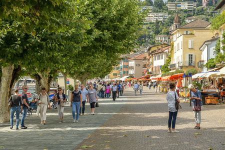 Ascona, Switzerland - September 2, 2018: People walking through promenade next to lake Maggiore in Ascona, Switzerland during sunny day in 2018のeditorial素材