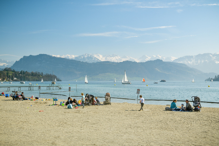 Luzern, Switzerland - March 31, 2019: People enjoying sunny weather in Lido in Luzern, Switzerland during beautiful spring day in 2019のeditorial素材