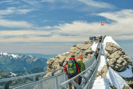 Glacier 3000, Switzerland - June 8, 2019: Tourists walking on peak to peak suspension bridge on top of Glacier 3000 in canton of Vaud, Switzerland during sunny day in Jue 2019のeditorial素材