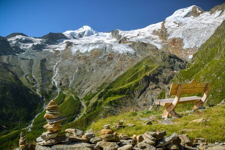 Just to sit and relax looking at majestic Fee Glacier located above Saas-Fee village in Swiss Alpsの写真素材