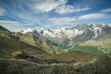 Walking trail on Hohsaas with beautiful views on Fee glacier and surrounding massive above Saas-Fee village in Switzerlandの写真素材