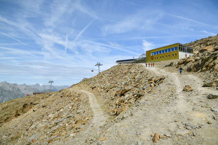 Saas-Grund, Switzerland - August 17, 2019: People walking close to top station on Hohsaas above the Saas-Grund village in Switzerland during August 2019のeditorial素材