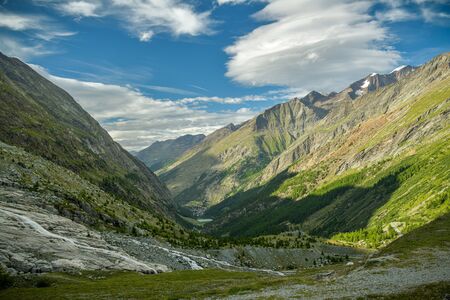 View on Saas valley surrounded by beautiful mountains as seen from Mattmark lake in Swiss Alpsの写真素材