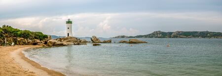 Sandy beach close to small lighthouse in city of Palau in northern part of Sardiniaの写真素材