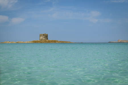 Ancient watchtower on small Island close to La Pelosa in Stintino on Sardinia island in Italyのeditorial素材