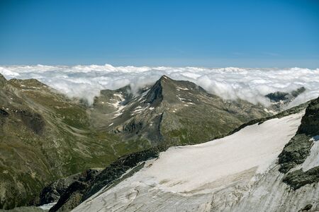 Clouds stopped by majestic Alps near Saas-Fee in Switzerlandの写真素材