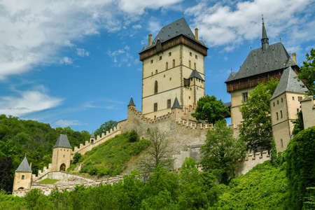 Karlstejn, Czech Republic - June 21, 2019: Overall look on historic Karlstejn castle in Karlstejn village, Czech Republic during sunny day in June 2019のeditorial素材