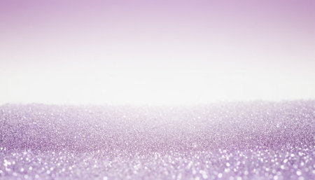 A soft, diffused featuring a layer of lavender glitter particles that creates a textured foreground. The glitter is rendered with a shallow depth of field, resulting in a gentle blur and a luminous, sparkling effect. The background is a smooth, soft gradient of light purple fading into white, providing a clean and airy contrast to the textured glitter. The overall mood is delicate, dreamy, and subtly festive.の素材