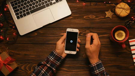 New York - September 10, 2017: Uber app. Man setting up a location and destination. Ordering a taxi, cab online. Christmas concept. top viewのeditorial素材