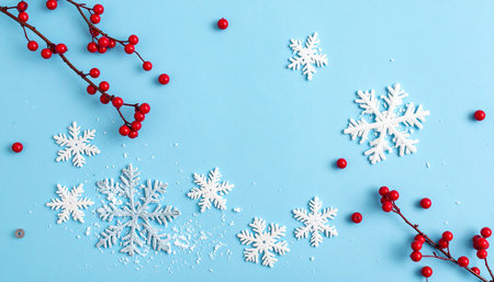 Christmas background with snowflakes and red berries on blue background.の素材