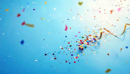 Colorful confetti and streamer on blue background with copy spaceの素材