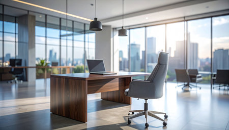 Laptop on table in modern office with panoramic windows and city viewの素材