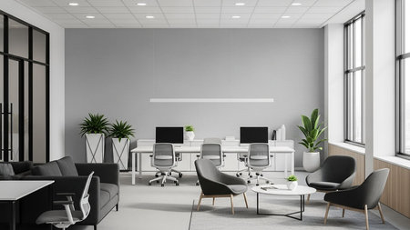 Interior of modern office with white walls, concrete floor, rows of computer tables with gray chairs and armchairs standing near them. 3d renderingの素材