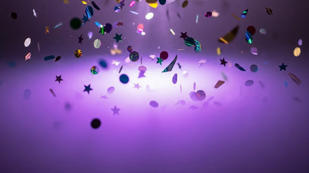 Colorful confetti with stars and bokeh lights on purple backgroundの素材