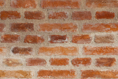diferent colors brick wall with mortar bricks betwen