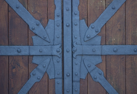 detail of black decorative fittings on an old oak doorの写真素材