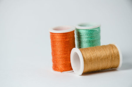 three thread rolls against white background