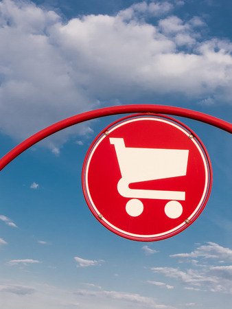 Shopping cart symbol against red backgroundの写真素材