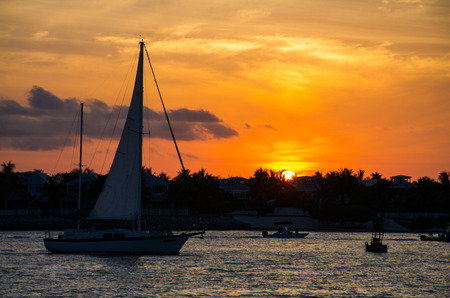 few boats on water during sunsetの写真素材