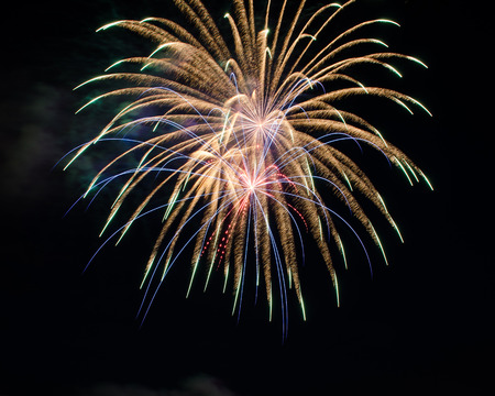 Fireworks up in the sky on the eve of 4th of Julyの写真素材