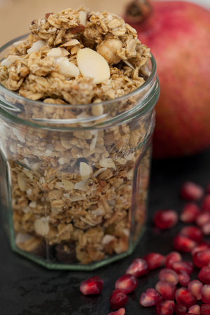 Granola in a Jar with Pomegranate and Pomegranate Seeds for Healthy Snackの写真素材