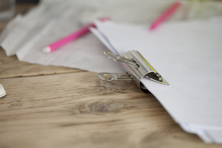 Retro Metal Binder Clip with Warm Vintage Tones Holding Paper Togetherの写真素材