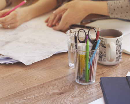 Two Women Working on some Papers in their Work Space