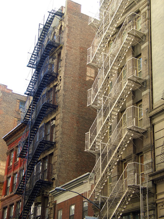 Black and white metal fire escape ladders, Manhattan, New Yorkの写真素材