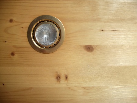 Golden spot light in pine wood panelの写真素材