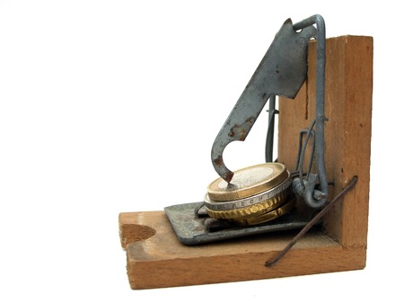 Money trap isolated on white, grunge mousetrap with euro coinsの写真素材