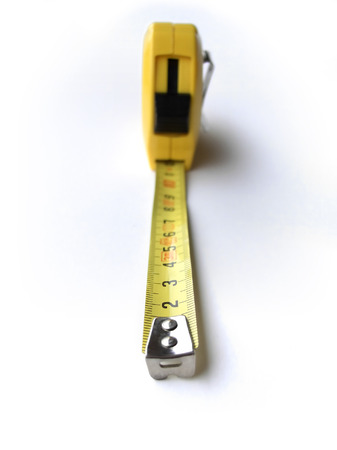 End of metal measuring tape, focus on number two, roll out of focus, isolated on white background, light from leftの写真素材