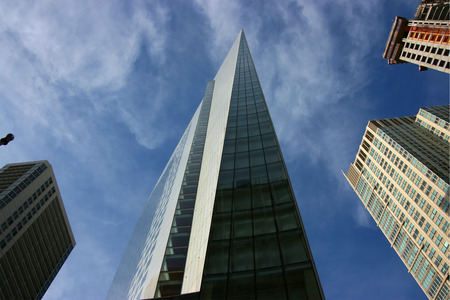Spiky skyscraper seen from below against blue sky, Chicago, Illinoisの写真素材