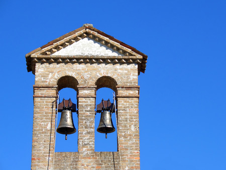 Two chuch bells on top of a country churchの写真素材