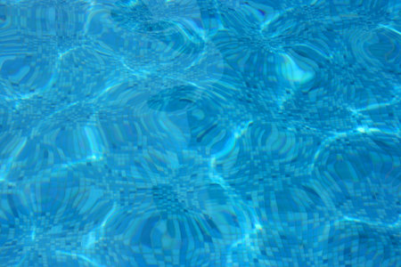 Pool bottom tiles seen through water ripples
