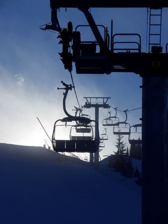 Chair lift silhouette on mountaintop, Friuli, Italy. Vertical.の写真素材
