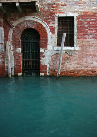 Entrance of a building on a city canal, Venice, Italyの写真素材